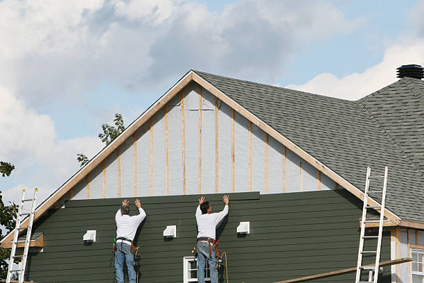 Professional Storm Damage Siding Repair technician working in Thompson, OH